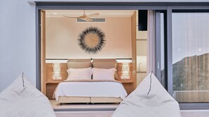 A modern bedroom with a large bed, two bedside lamps, a ceiling fan, and a large window. - Escape View Villa Lefkada (Fterno)