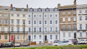 A row of terraced houses with a bench in the foreground. - Host & Stay | The Connell (Whitby)