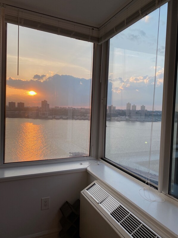 Enjoy breathtaking views of the city skyline and water from this corner room's large window.