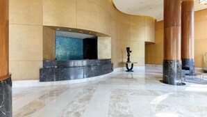 A spacious lobby with marble flooring, a curved wall, and a reception desk. - NYC Luxury 3bed/3 bath Westside Manhattan  (New York)