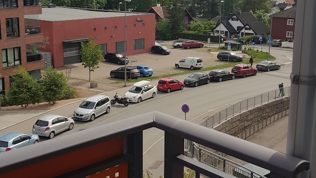 A residential area with a parking lot, buildings, and a view of a hilly landscape. - 2-bedroom apartment in central Oslo. Located right next to Løren subway (Oslo)