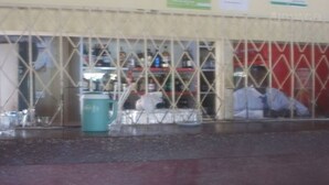Zona de bar con mostrador y estanterías llenas de botellas.