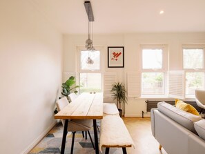 Enjoy meals with family and friends at the spacious dining table, accompanied by a bench.