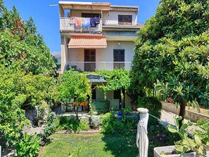 Enjoy a tranquil retreat with a balcony overlooking lush greenery and a beautifully maintained garden.