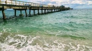 A pier extending into the sea with a building at the end. - Sea Star Suites By The Sea #7 Steps 2 Beach & Pubs (Lauderdale-by-the-Sea)