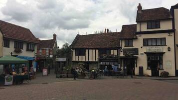 A traditional British pub with outdoor seating, a sign for 'Nature's Treasures', and a 'Blackfoot' sign visible in the background.
