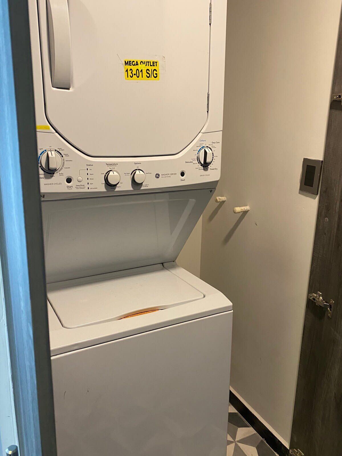 A front-loading washing machine with a control panel and a door.