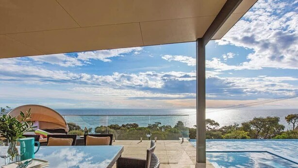 A patio with a view of the sea, a swimming pool, and a tent. - The Ocean's Edge, Luxury Entertainer with Views (Mount Martha)