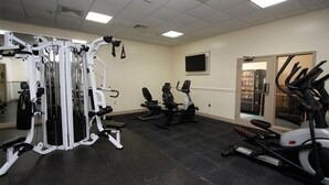 A gym with cardio machines, weight machines, and a mirrored wall. - MB Renaissance 1516- 2BR/2BA Oceanfront Condo in Myrtle Beach (Myrtle Beach)