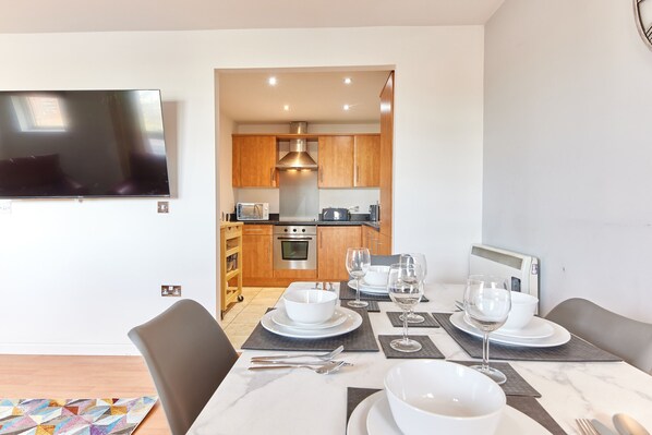 Enjoy meals in this stylish dining area with a flat-screen TV and modern kitchen.