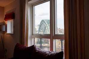 Enjoy a city view from the large window, featuring a sofa and floor lamp.