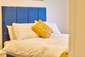 Restful retreat with a neatly made bed and minimalist decor.