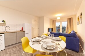 Enjoy meals and social gatherings in this well-appointed living space with a dining area for four and a cozy seating arrangement.