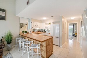 Enjoy cooking in this well-equipped kitchen with a central island and stainless steel appliances.