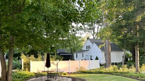 A house with a stone patio, a lawn, and a wooden fence. - Downtown Douglas-Craftsman Charm-Sleeps 6 (Douglas)