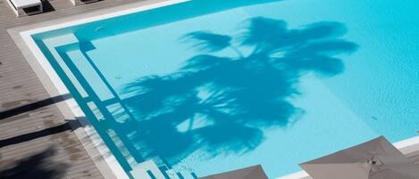 Seasonal outdoor pool, open 9:30 AM to 6:30 PM, pool umbrellas