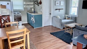 A compact living space with a kitchen, dining area, and seating area.