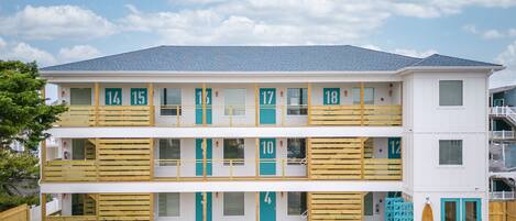 A two-story motel with numbered balconies and a row of bicycles parked in front.