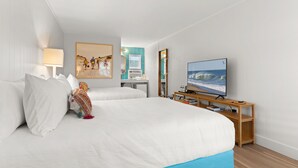 A hotel room with two beds, a TV, a desk, and a painting on the wall. - The Surf Shanty Motel (Dewey Beach)