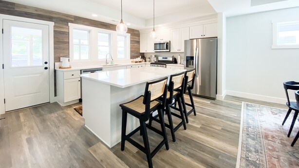 A modern kitchen with a large island, stainless steel appliances, and a farmhouse-style ceiling. - Modern New-Build w/ Screened Porch - Walk to Beach (Michigan City)