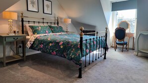A bedroom with a bed, bedside tables, a chair, and a window. - NEW Fabulous 2BD Maisonette Dunfermline, Fife (Dunfermline)