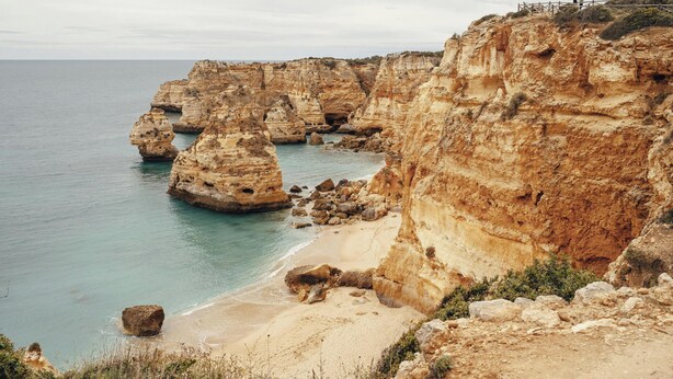 Un paisaje costero con acantilados y una playa.