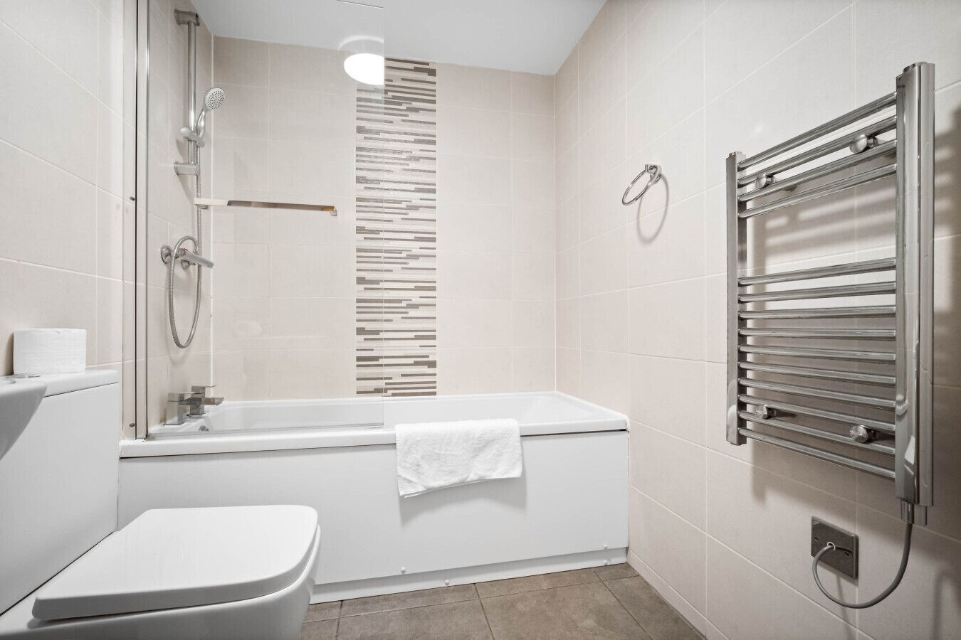 Un baño moderno con bañera, inodoro y ducha.