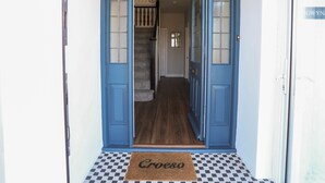 A blue door with a doormat reading "Croeso" leading to a staircase. - Gwynant - Bull Bay (Amlwch)