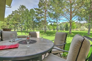 Outdoor dining area with gas firepit and gorgeous golf course views