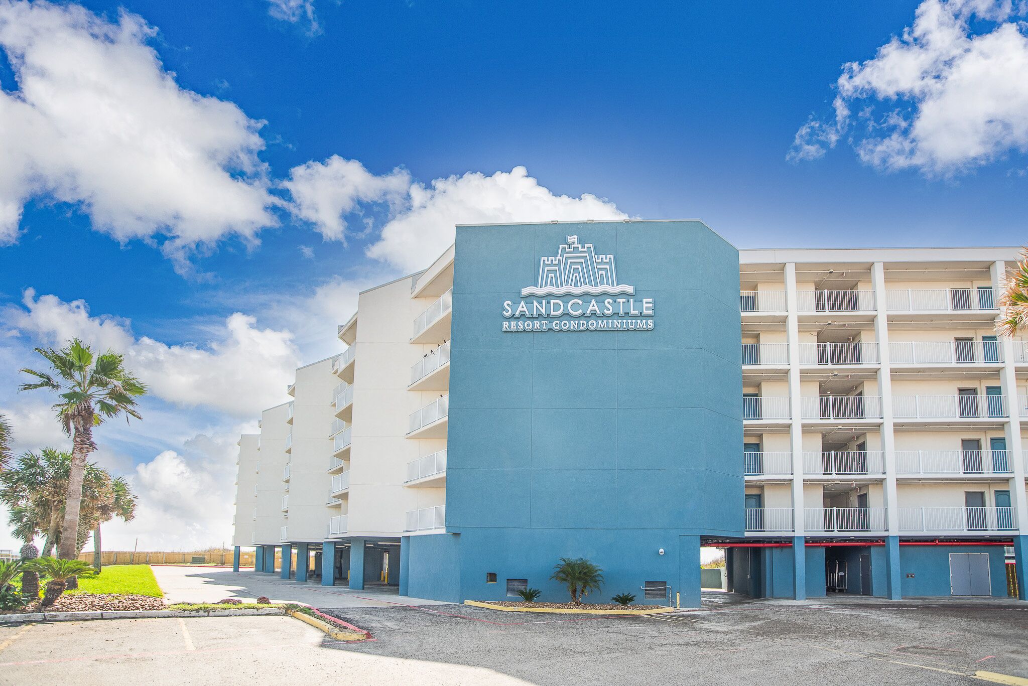 A building with a sign reading 'Sandcastle Resort Condominiums.'