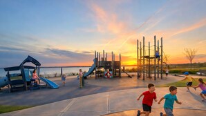 A playground with slides and climbing structures near a body of water during sunset. - The Loft at Oakland Beach 
Ask About Off-season Discounts 
5 min from Airport. (Warwick)