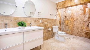 A modern bathroom with two sinks, a toilet, and a shower. - Breathtaking 5BR/3BA Villa near Hollywood Beach (Hollywood)