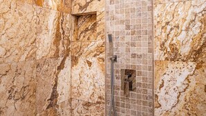 A shower with a marble wall and a tiled floor. - Breathtaking 5BR/3BA Villa near Hollywood Beach (Hollywood)