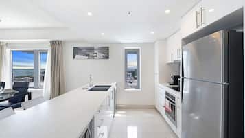 Fridge, coffee/tea maker, high chair, cookware/dishes/utensils