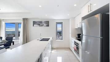 Fridge, coffee/tea maker, high chair, cookware/dishes/utensils