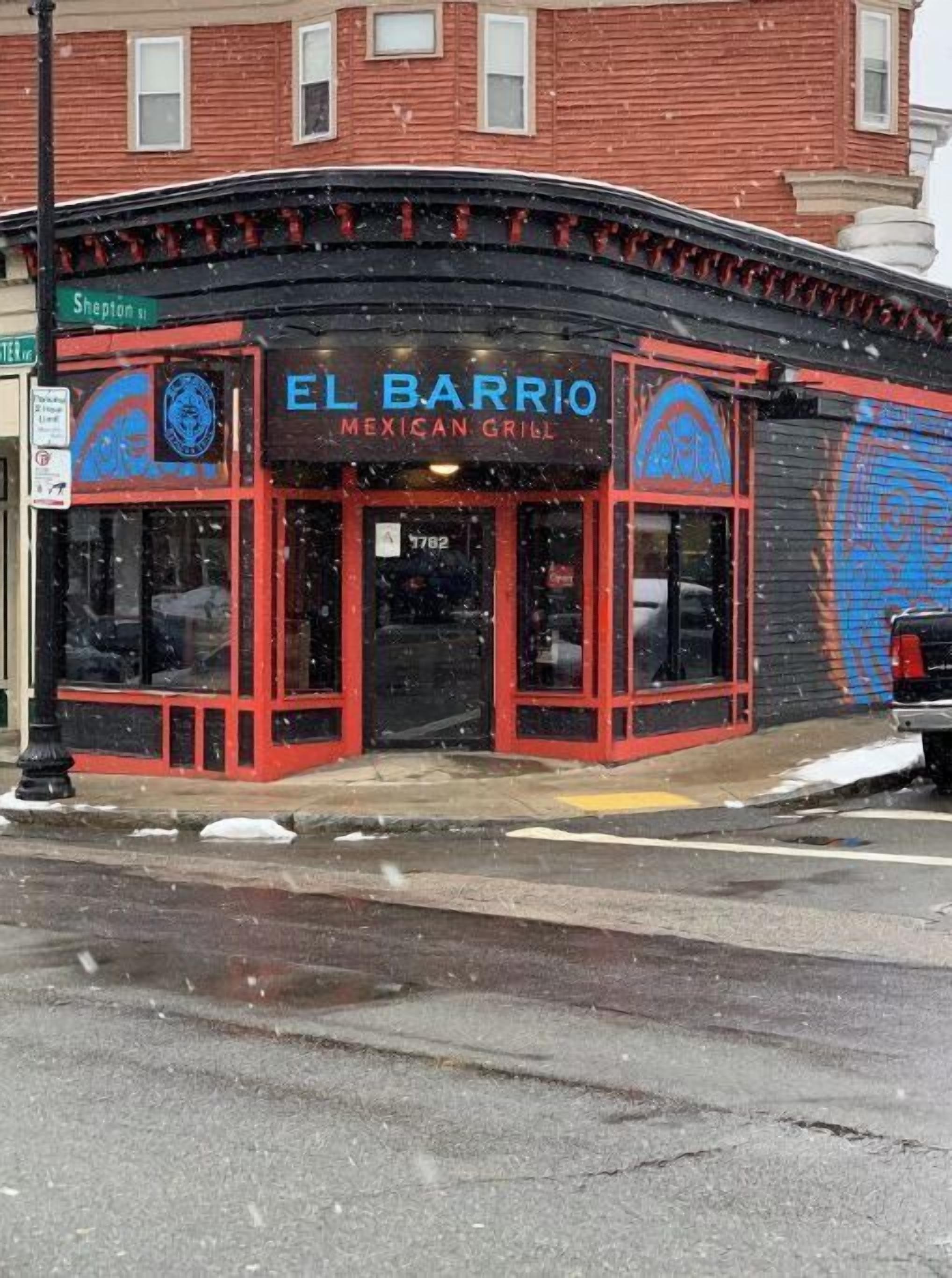 A building with a sign reading "EL BARRIO Mexican Grill".