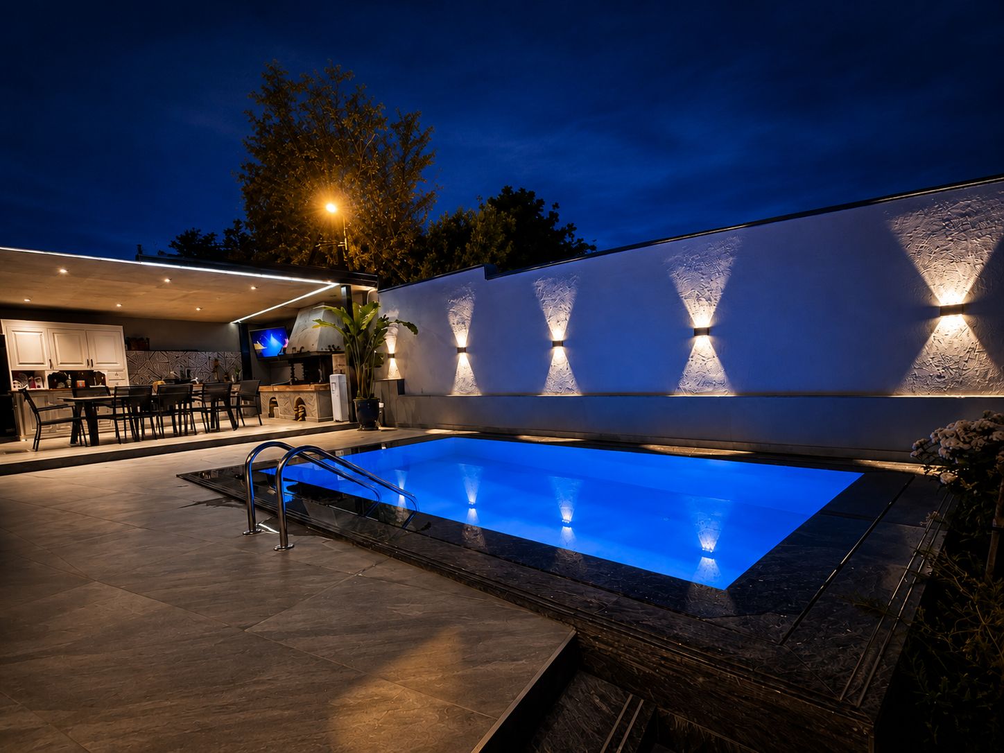 A swimming pool with a modern design, a bar area, and a well-lit outdoor space.