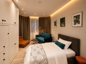 A modern hotel room with a bed, a sofa, a desk, and a wardrobe. - Joan Luxury Villa Apt with private pool & Gym (Tirana)
