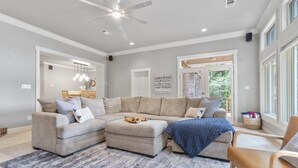 A spacious living room with a sectional sofa, ottoman, and a coffee table. - Lake Hamilton Waterfront Home Dock, Firepit, Sleeps 12 (Hot Springs)