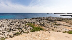 A rocky coastal landscape with clear skies. - Binilaya - Charming 3-bedroom house - seafront (Binibèquer Nou)