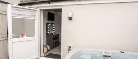 A bathroom with a vanity, a mirror, and a shower.