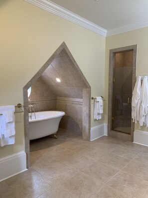 A bathroom with a freestanding bathtub, a glass shower enclosure, and a vanity with a towel rack. - Private oasis, fully furnished, ready to move in. Luxury finishes.  6beds 7baths (Biloxi)
