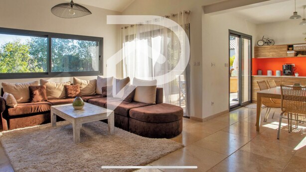 A modern living room with a sofa, coffee table, and a view of the outdoors. - Beautiful villa near Uzès (Blauzac)
