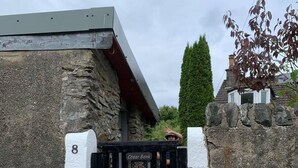 A stone building with a black gate labeled "Cedar Bank." - Cedarbank's - The Little Art House - dog Friendly (Dunoon)