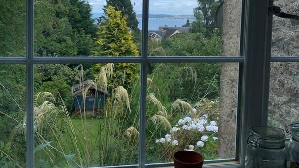 A window with a view of a garden and a distant landscape. - Cedarbank's - The Little Art House - dog Friendly (Dunoon)