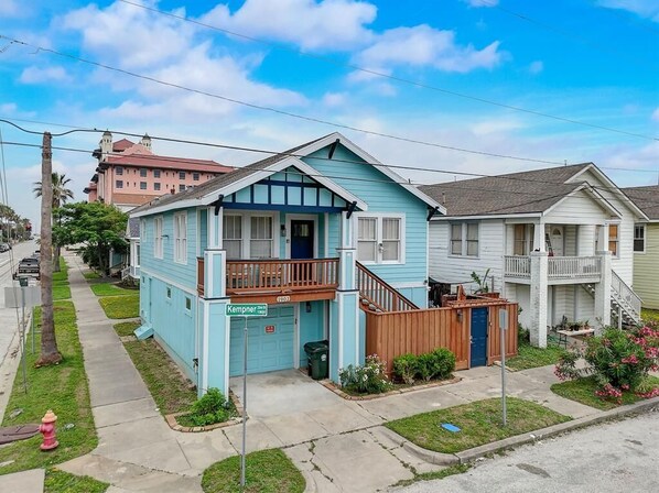 A two-story house with a blue exterior and a front porch.
