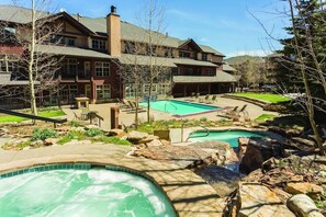 Relax by the pool or unwind in the hot tub amidst lush surroundings and a serene waterfall.