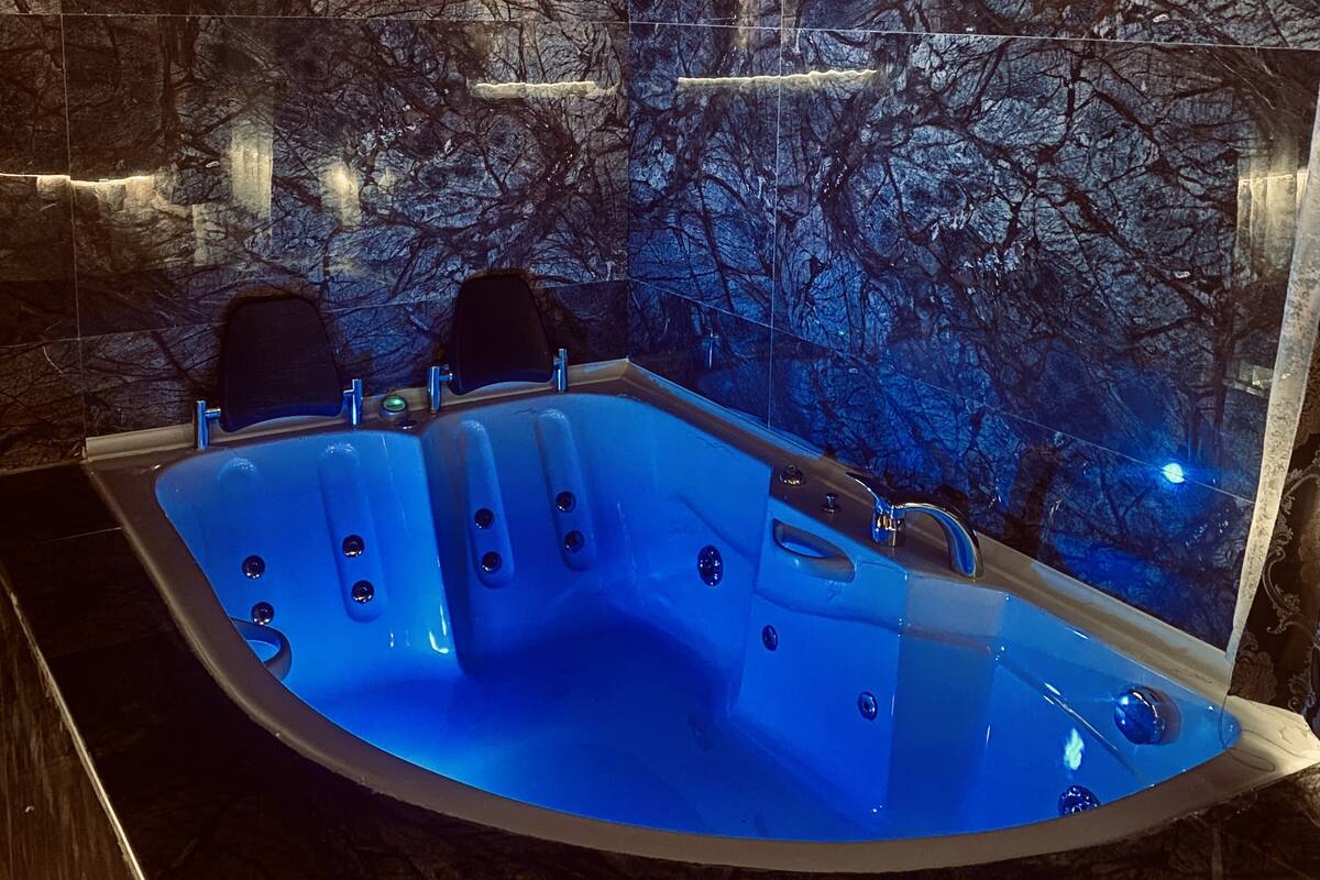 Room with Jacuzzi and Fireplace | Premium bedding, desk, laptop workspace, soundproofing