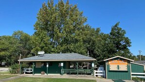 A small, green building with a covered picnic area and a playground. - Comfy Clean & Cute (Marion)