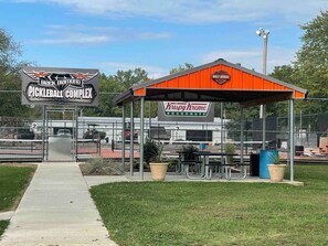 A baseball field with a sign for Black Diamond Pickleball Complex and Krispy Kreme Doughnuts. - Comfy Clean & Cute (Marion)